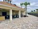 Outdoor patio area with seating, ceiling fans, and a convenient outdoor kitchen for social gatherings at 8438 Wheat Stone Dr, Zephyrhills, FL 33540