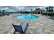 Community pool with poolside lounge chairs and an inviting outdoor gathering space at 8438 Wheat Stone Dr, Zephyrhills, FL 33540