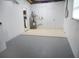 Clean basement space, featuring a water heater, white painted walls, and two entrance ways at 9062 Sunrise Dr, Largo, FL 33773