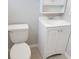 Cozy bathroom with a toilet and vanity, featuring a medicine cabinet and a bright, clean aesthetic at 9062 Sunrise Dr, Largo, FL 33773