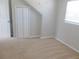 Bedroom featuring bi-fold closet doors, neutral paint, and a window for natural lighting at 9062 Sunrise Dr, Largo, FL 33773