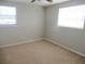 Bedroom with light-colored carpet, neutral walls, and natural light from the windows at 9062 Sunrise Dr, Largo, FL 33773