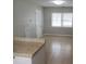 Bright living room featuring neutral paint, tile floors, and plenty of natural light from the window at 9062 Sunrise Dr, Largo, FL 33773
