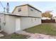 Exterior side and back of the house with light gray siding and a backyard showing a privacy fence at 9062 Sunrise Dr, Largo, FL 33773