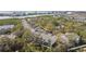 Aerial view of white townhomes featuring mature landscaping and a street lined with parked cars at 9770 Indian Key Trl # 102, Seminole, FL 33776
