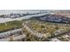 Aerial view of townhome community with mature landscaping and glimpses of a pool and waterfront views at 9770 Indian Key Trl # 102, Seminole, FL 33776