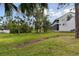 Lush green backyard area featuring mature trees and well-maintained lawn near property at 9770 Indian Key Trl # 102, Seminole, FL 33776