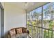 Relaxing screened in patio with comfortable wicker seating offers tranquil outdoor views at 9770 Indian Key Trl # 102, Seminole, FL 33776