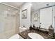 Bathroom featuring a glass-enclosed shower, granite counters, and modern fixtures at 9770 Indian Key Trl # 102, Seminole, FL 33776