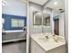 View from bathroom to bedroom with large bed and bright window, shows open plan at 9770 Indian Key Trl # 102, Seminole, FL 33776