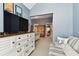 Spacious bedroom includes a dresser, television, and a comfortable seating area with charming decor at 9770 Indian Key Trl # 102, Seminole, FL 33776