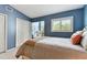 Cozy bedroom features blue walls, a striped bedspread, and bright, shuttered window at 9770 Indian Key Trl # 102, Seminole, FL 33776