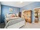 Blue bedroom with white furniture and ample closet space and natural light at 9770 Indian Key Trl # 102, Seminole, FL 33776