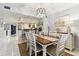 Dining area with view of kitchen, modern chandelier, farm art and hutch at 9770 Indian Key Trl # 102, Seminole, FL 33776