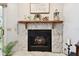 Stone fireplace with wood mantle and decor at 9770 Indian Key Trl # 102, Seminole, FL 33776