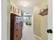 Upstairs hallway with traditional wooden dresser, leading to bedroom with ceiling fan and outdoor patio access at 9770 Indian Key Trl # 102, Seminole, FL 33776