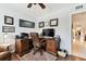 Functional home office has a large desk, comfortable chair, and natural light at 9770 Indian Key Trl # 102, Seminole, FL 33776