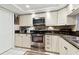 Well-equipped kitchen with stainless steel appliances, granite countertops, and white cabinets at 9770 Indian Key Trl # 102, Seminole, FL 33776