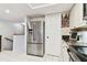 Spacious kitchen featuring stainless steel refrigerator, tile flooring, and white cabinets at 9770 Indian Key Trl # 102, Seminole, FL 33776