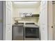 Convenient laundry closet features modern washer and dryer, and extra shelving for storage at 9770 Indian Key Trl # 102, Seminole, FL 33776