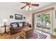 Comfortable living room features stylish decor, a ceiling fan, and a sliding glass door for natural light at 9770 Indian Key Trl # 102, Seminole, FL 33776