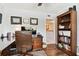 Home office with a dark wood desk, leather office chair, and built-in bookshelves at 9770 Indian Key Trl # 102, Seminole, FL 33776