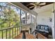 Screened patio with wood flooring features comfortable seating and a picturesque view at 9770 Indian Key Trl # 102, Seminole, FL 33776