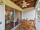 Relaxing patio features a ceiling fan, wood flooring, and a lovely view of the outdoors at 9770 Indian Key Trl # 102, Seminole, FL 33776