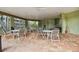 Covered patio area with multiple tables and chairs for outdoor dining and socializing at 9770 Indian Key Trl # 102, Seminole, FL 33776