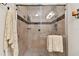 Elegant glass shower with tile surround, built-in shelves, and modern fixtures at 9770 Indian Key Trl # 102, Seminole, FL 33776