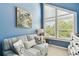 Charming sitting area offers a comfortable striped couch and a picturesque view through a large window at 9770 Indian Key Trl # 102, Seminole, FL 33776