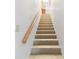 Bright staircase with carpet and a wooden handrail at 9770 Indian Key Trl # 102, Seminole, FL 33776