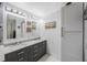 Modern bathroom featuring double sinks, stone countertops, and bright lighting at 1036 Hamilton Ave, Tarpon Springs, FL 34689