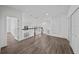 Upper-level hallway overlooks living room with natural lighting and wood flooring at 10436 Greendale Dr, Tampa, FL 33626