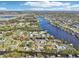 Stunning aerial view of waterfront homes along a canal under a bright blue sky with scattered clouds at 106 W North Branch Rd, Ruskin, FL 33570