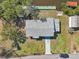 Overhead view of a home featuring a long driveway and canal in the back at 106 W North Branch Rd, Ruskin, FL 33570