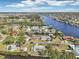 Beautiful aerial view of waterfront homes lining a canal under a bright blue sky with scattered clouds at 106 W North Branch Rd, Ruskin, FL 33570