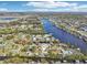 Stunning aerial view of waterfront homes along a canal under a bright blue sky and a locator pin at 106 W North Branch Rd, Ruskin, FL 33570