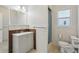 Bright bathroom featuring a modern vanity, decorative wood-look tile, and a walk-in shower at 106 W North Branch Rd, Ruskin, FL 33570