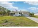 Charming single-story home with well-maintained lawn, carport, and attached garage at 106 W North Branch Rd, Ruskin, FL 33570
