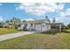 Inviting home with a manicured lawn, an attached garage, a convenient carport, and a welcoming front entrance at 106 W North Branch Rd, Ruskin, FL 33570