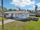 A beautiful single-story home with an attached garage and a large, green yard at 106 W North Branch Rd, Ruskin, FL 33570