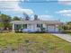 Charming single-story home featuring a well-maintained lawn, an attached garage, and cozy curb appeal at 106 W North Branch Rd, Ruskin, FL 33570