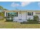 Inviting front porch with black accents and manicured landscaping at 106 W North Branch Rd, Ruskin, FL 33570