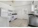 Bright kitchen featuring stainless steel sink, countertops, appliances, and tiled floor at 106 W North Branch Rd, Ruskin, FL 33570