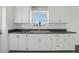 Bright kitchen featuring stainless steel sink, cabinetry, and a window at 106 W North Branch Rd, Ruskin, FL 33570