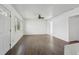 Spacious living room featuring wood-look tile flooring, a ceiling fan, and plenty of natural light from the windows at 106 W North Branch Rd, Ruskin, FL 33570