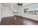 Bright living area featuring wood-look tile flooring, white walls, and a view of the kitchen at 106 W North Branch Rd, Ruskin, FL 33570