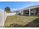 Fenced backyard with lush green grass and a screened-in patio at 10604 Scenic Hollow Dr, Riverview, FL 33578