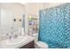 Bathroom featuring a vanity with sink and decorative blue patterned shower curtain at 10604 Scenic Hollow Dr, Riverview, FL 33578